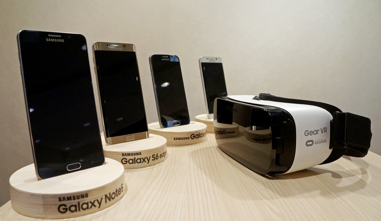 Samsung Gear VR headset next to supporting phones