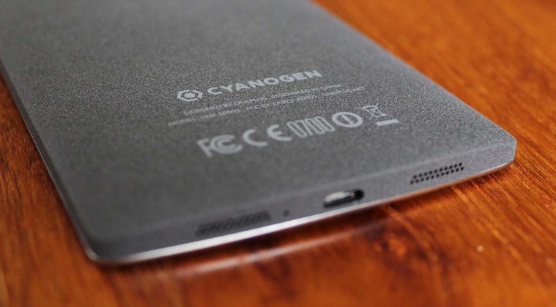 Oneplus One Cell Phone on an oak table with a shallow depth of field