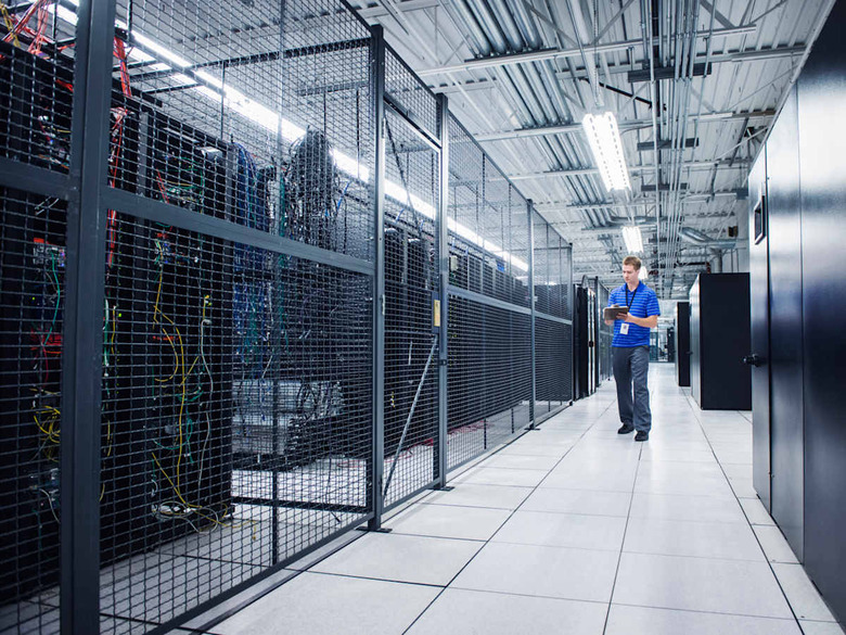 Caucasian technician using digital tablet in server room