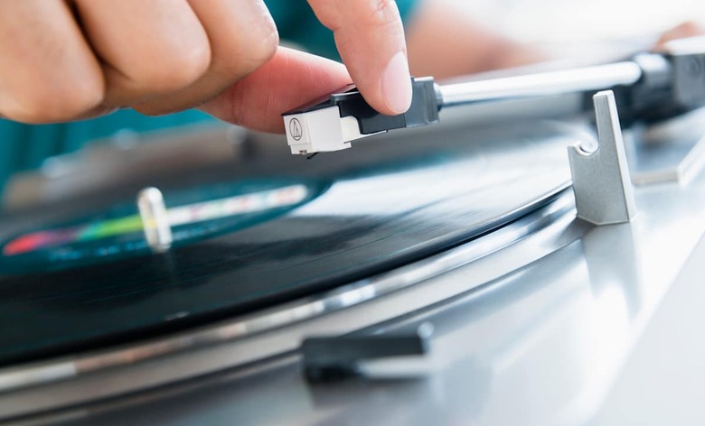 Close up of mixed race man playing vinyl record