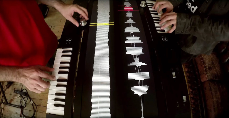 Two people play the Collidoscope