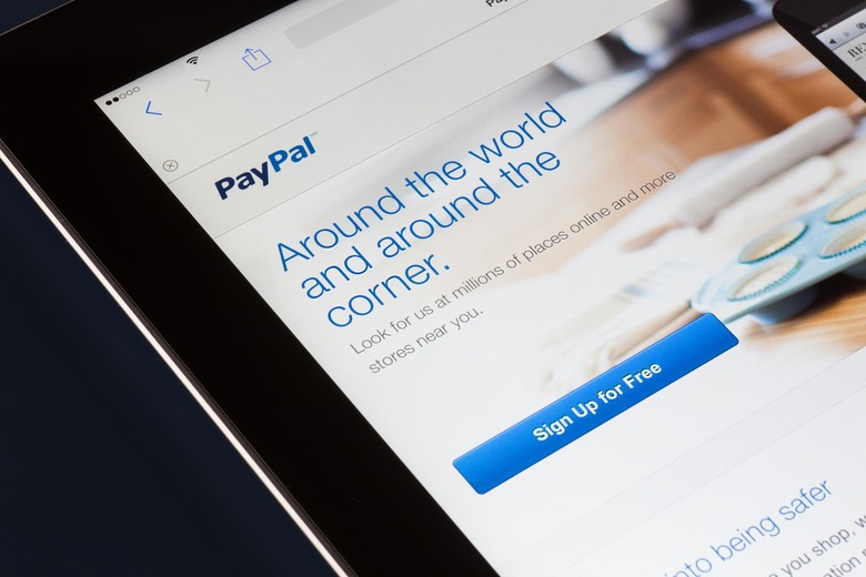 NEW YORK CITY - FEB. 3, 2014: Paypal website displayed on tablet screen against dark background. Established in 1999, PayPal a