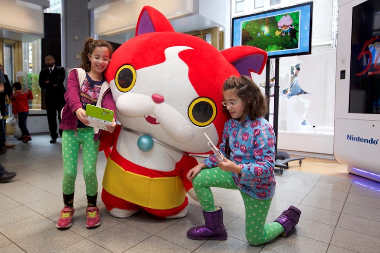 In this photo provided by Nintendo of America, fans meet and interact with YO-KAI WATCH character Jibanyan at Nintendo World in New York on Nov. 7, 2015, as part of the YO-KAI WATCH launch event. YO-KAI WATCH launched on Nov. 6, 2015 and is available exclusively for the Nintendo 3DS family of systems.