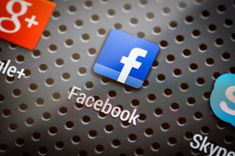 BELCHATOW, POLAND - APRIL 10, 2014: Closeup photo of Facebook icon on mobile phone screen. Popular social network.