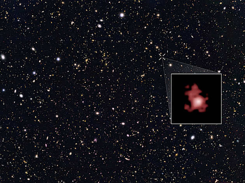 This image shows the position of the most distant galaxy discovered so far within a deep sky Hubble Space Telescope survey called GOODS North (Great Observatories Origins Deep Survey North). The survey field contains tens of thousands of galaxies stretching far back into time. The remote galaxy GN-z11, shown in the inset, existed only 400 million years after the Big Bang, when the Universe was only 3 percent of its current age. It belongs to the first generation of galaxies in the Universe and its discovery provides new insights into the very early Universe. This is the first time that the distance of an object so far away has been measured from its spectrum, which makes the measurement extremely reliable. GN-z11 is actually ablaze with bright, young, blue stars but these look red in this image because its light was stretched to longer, redder, wavelengths by the expansion of the Universe.