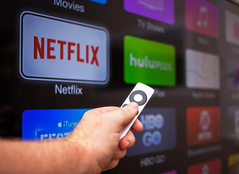 Las Vegas, USA - October 24, 2014: A man in his 30's browsing the channel selections on Apple TV at his home in Las Vegas. Apple TV is a digital media player developed and sold by Apple Inc. It is a small network appliance and entertainment device that streams movies and television shows to a television screen.