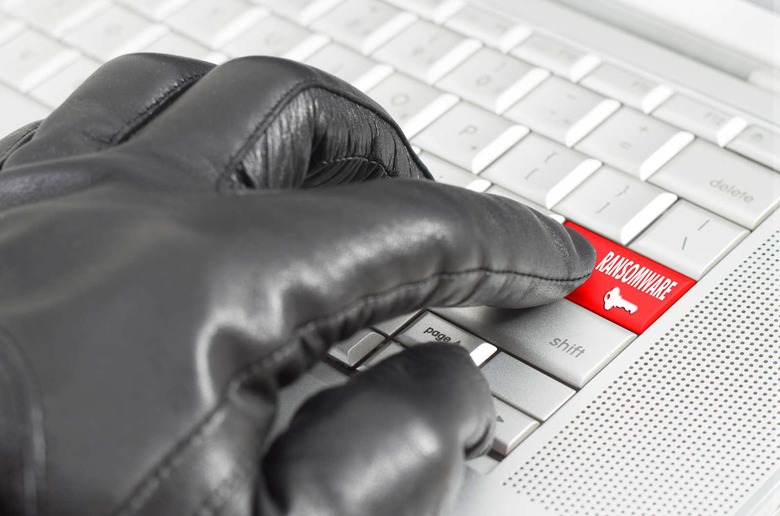 Ransomware concept with hand wearing black
