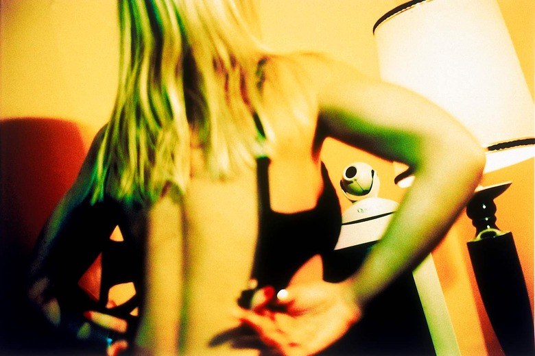 cyber sex depicted by woman removing underwear in front of computer