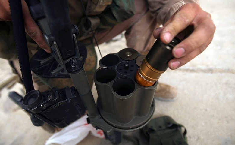 A Marine from 1st Battalion, 24th Marine Regiment loads 40 mm grenades during a training exercise at Camp Fallujah's Eagle Range