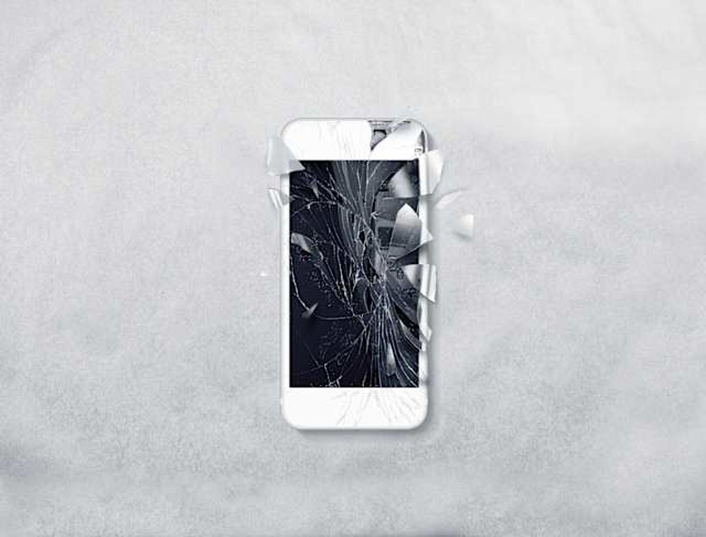 Broken mobile phone screen, scattered shards.