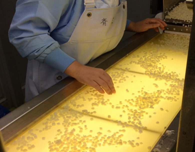 Kewpie's inspectors looking at diced potatoes