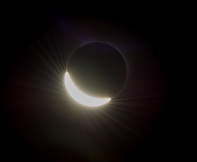 The last glimmer of the sun is seen as the moon makes its final move over the sun during the total solar eclipse on Monday, August 21, 2017 above Madras, Oregon. A total solar eclipse swept across a narrow portion of the contiguous United States from Lincoln Beach, Oregon to Charleston, South Carolina. A partial solar eclipse was visible across the entire North American continent along with parts of South America, Africa, and Europe. Photo Credit: (NASA/Aubrey Gemignani)