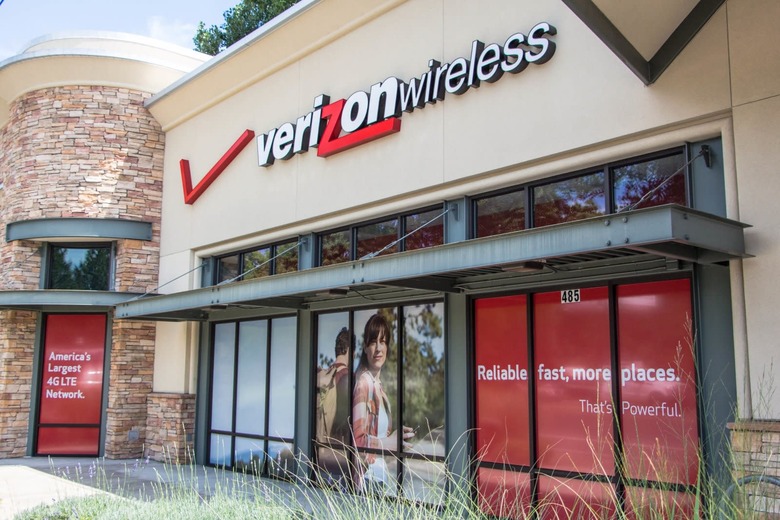 Eugene, Oregon, USA - July 8, 2014: Verizon Wireless Store location in Eugene, Oregon. Verizon sells cell phone services as well as cable across the United States with more than a 1000 locations. This is a picture of Verizon's advertising on the side of the building as vehicles pass by.