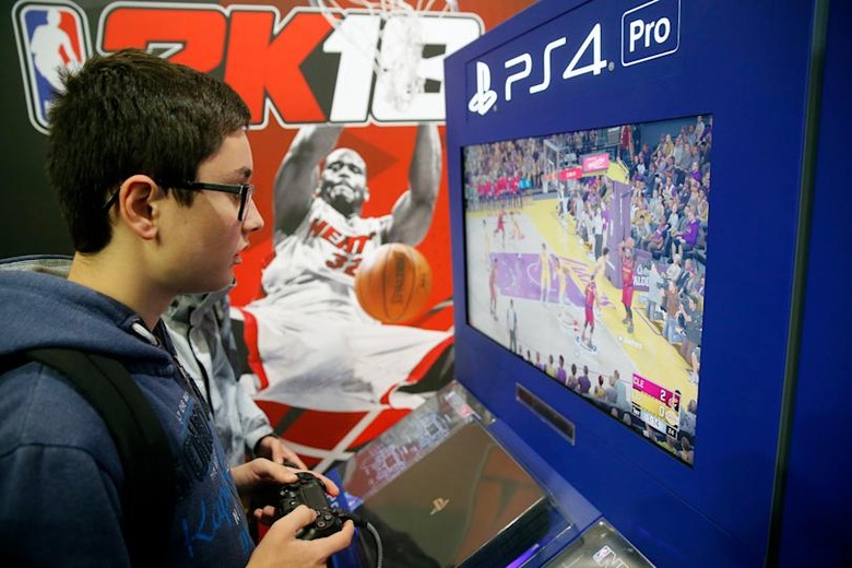 PARIS, FRANCE - NOVEMBER 01: Gamers play the video game 'NBA 2K18' developed by Visual Concepts and published by 2K Sports on Sony PlayStation game consoles PS4 Pro during the 'Paris Games Week' on November 01, 2017 in Paris, France. 'Paris Games Week' is an international trade fair for video games to be held from October 31 to November 5, 2017. (Photo by Chesnot/Getty Images)