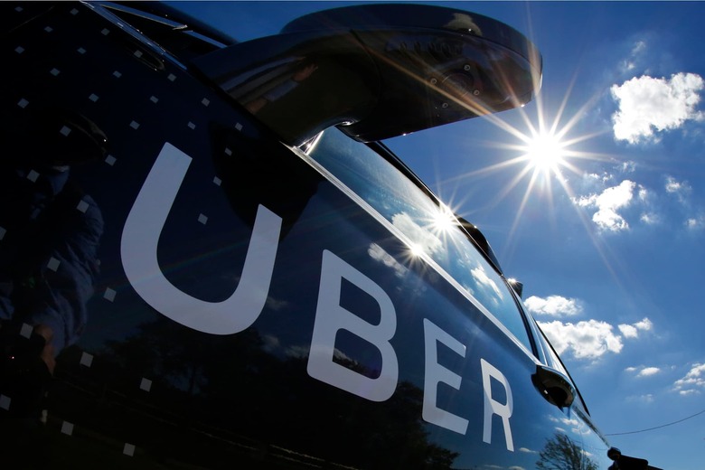 FILE - In this Monday, Sept. 12, 2016, file photo, a self-driving Uber sits ready to take journalists for a ride during a media preview in Pittsburgh. A federal criminal investigation into alleged espionage at Uber has indefinitely delayed a trial over whether the beleaguered ride-hailing service stole self-driving car technology from Waymo, a spinoff from Google. (AP Photo/Gene J. Puskar, File)