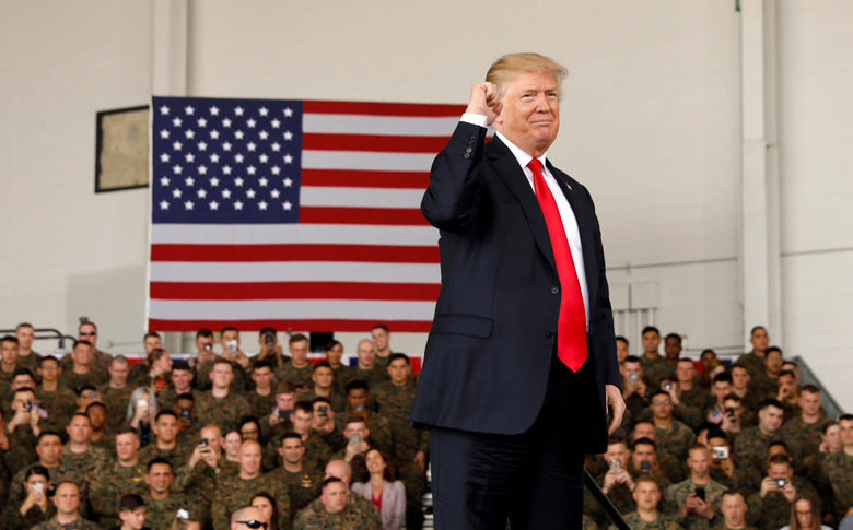 U.S. President Donald Trump pumps his fist after speaking at Marine Corps Air Station Miramar in San Diego, California, U.S. March 13, 2018. REUTERS/Kevin Lamarque TPX IMAGES OF THE DAY