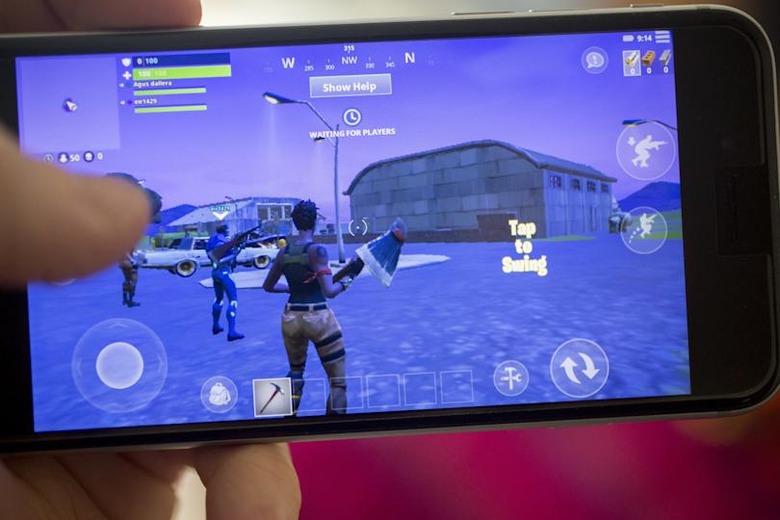 The Epic Games Inc. Fortnite: Battle Royale video game is displayed for a photograph on an Apple Inc. iPhone in Washington, D.C., U.S., on Thursday, May 10, 2018. Fortnite, the hit game that's denting the stock prices of video-game makers after signing up 45 million players, didn't really take off until it became free and a free-for-all. Photographer: Andrew Harrer/Bloomberg via Getty Images