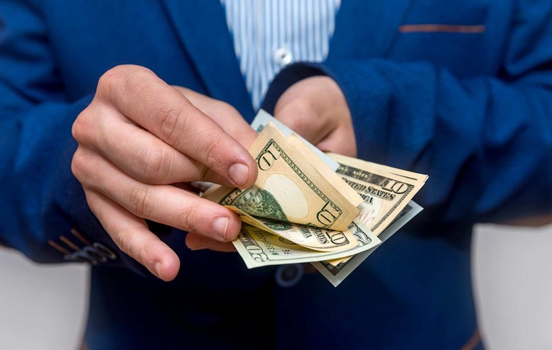 Male hands counting dollar banknotes close up