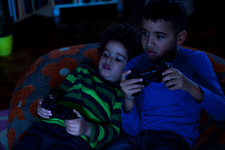 Two Friends Playing Video Game, at Night