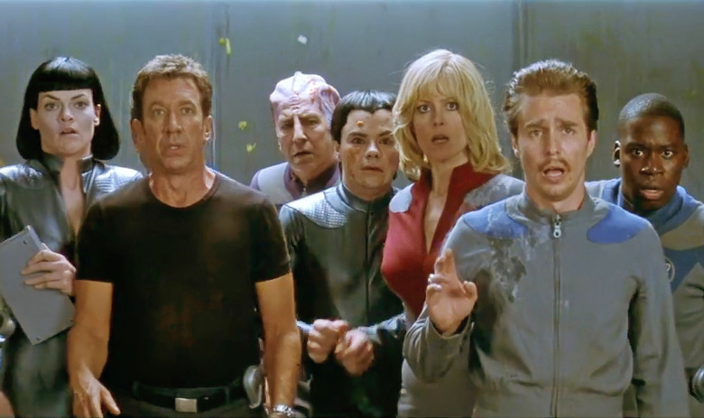 Still from the 1999 film ‘Galaxy Quest.’ Seven cast members (including Tim Allen, Alan Rickman, Sigourney Weaver and Sam Rockwell) face the camera, looking aghast at something they see. 