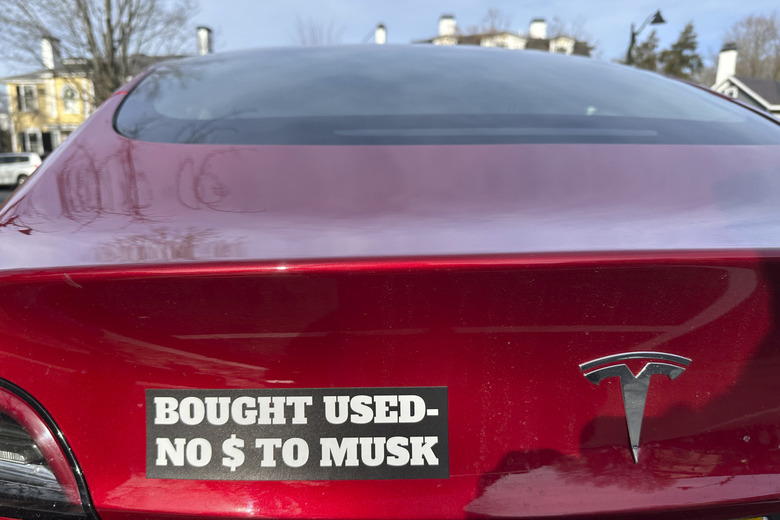 A Tesla with a sticker referring to the car's purchase is shown on Sunday, Dec. 15, 2024 in Concord, Mass.