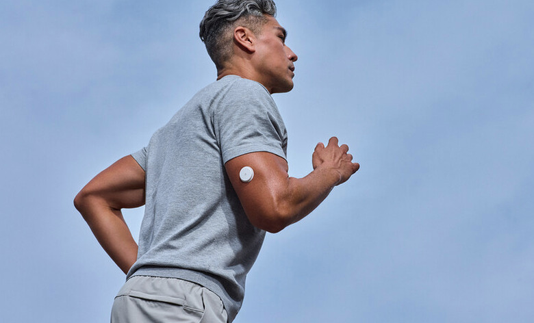 A guy running wearing a sensor.