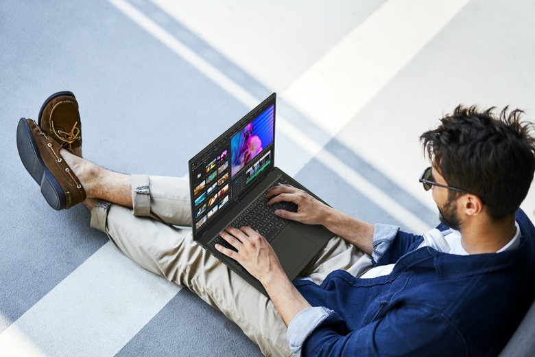 A chilled out man relaxes while using a laptop.