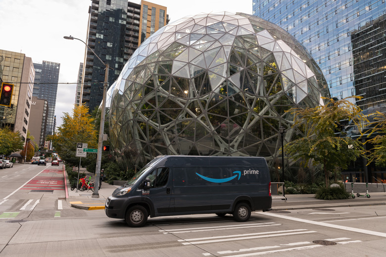 Seattle, USA - Oct 18, 2021: Late in the day an Amazon prime delivery truck passing the Spheres at the Amazon HQ.