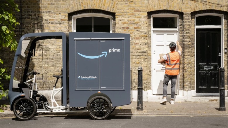 Amazon cargo e-bike and a courier knocking on a door.