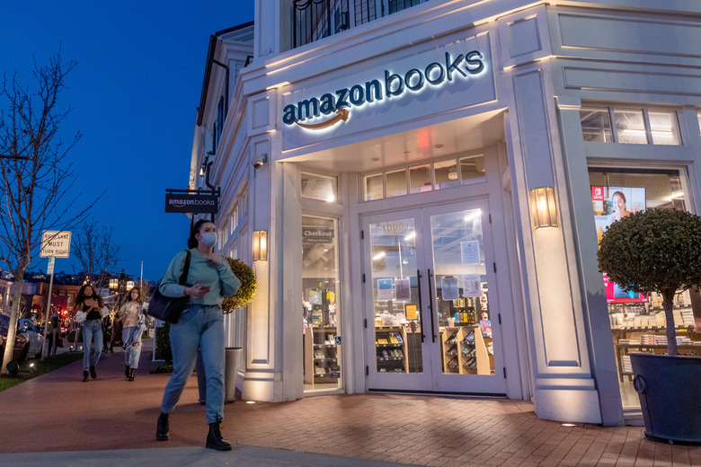 LOS ANGELES, CALIFORNIA - APRIL 24: People wearing masks walk past an Amazon Books in the Pacific Palisades amid the coronavirus pandemic on April 24, 2021 in Los Angeles, California. Los Angeles County moved into Covid-19 orange tier restrictions on April 5 allowing increased capacity at restaurants, movie theaters and museums. (Photo by Alexi Rosenfeld/Getty Images)