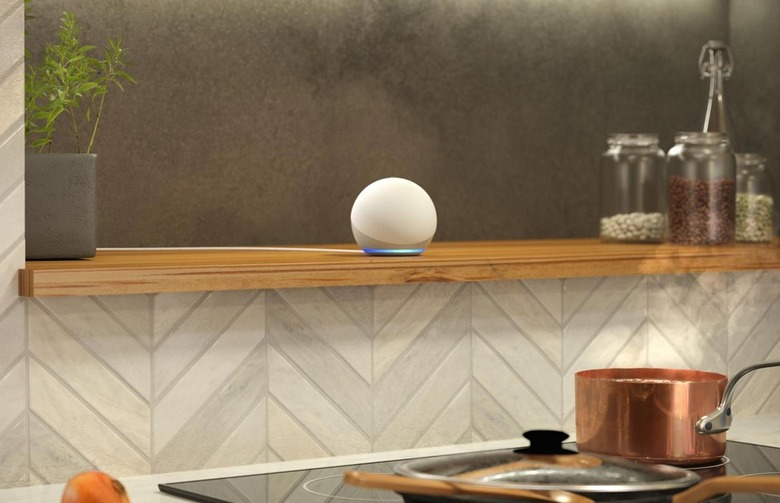Amazon's Echo Dot smart speaker on a kitchen shelf.