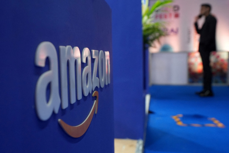 A visitior stands near a logo of Amazon during the annual Retail Leadership Summit in Mumbai, India, February 27, 2025. REUTERS/Hemanshi Kamani/ File Photo