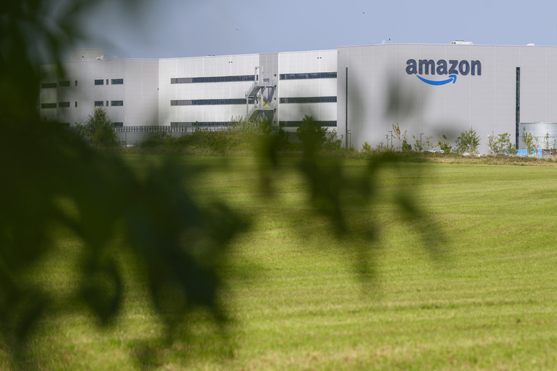 This photograph shows the logo of US multinational company Amazon displaying on the facade of the distribution centre in Augny, near Metz, eastern France, on August 29, 2024. The Augny site, equipped with cutting-edge technology which guarantees the safety and well-being of employees, covers 180,000 square metres and employs around 4,000 people. Amazon reintroduces consumer visits that had been interrupted during COVID19, to rehabilitate its image, damaged by criticism of working conditions in its warehouses. (Photo by Jean-Christophe VERHAEGEN / AFP) (Photo by JEAN-CHRISTOPHE VERHAEGEN/AFP via Getty Images)