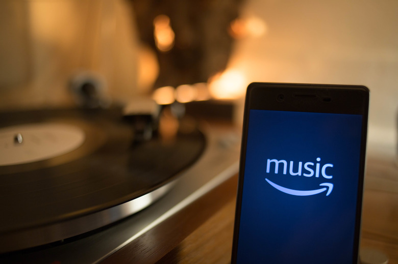BANGKOK, THAILAND - 2019/01/09:  In this photo illustration, the Amazon Music application seen displayed on an Android smartphone with a vintage turntable in the background. (Photo Illustration by Guillaume Payen/SOPA Images/LightRocket via Getty Images)