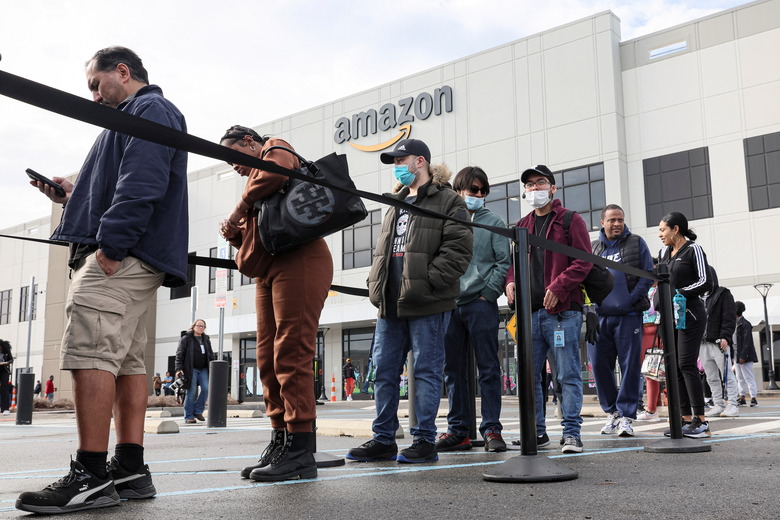 Workers stand in line to cast ballots for a union election at Amazon's JFK8 distribution center, in the Staten Island borough of New York City, U.S. March 25, 2022.  REUTERS/Brendan McDermid.