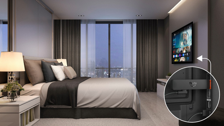 A picture with a diagram showing where the Fire TV Stick HD would slip behind a TV in a bedroom.