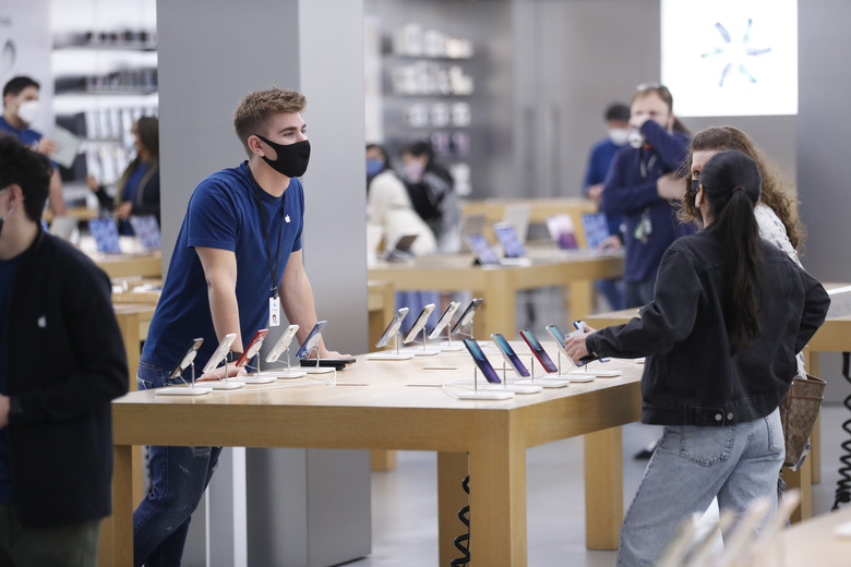 TAMPA, FL - NOVEMBER 26: The Apple store employee helps customers during Black Friday at International Plaza on November 26, 2021 in Tampa, United States. More shoppers are expected to shop in than last year after the COVID-19 pandemic caused the quietest Black Friday in 20 years. (Photo by Octavio Jones/Getty Images)