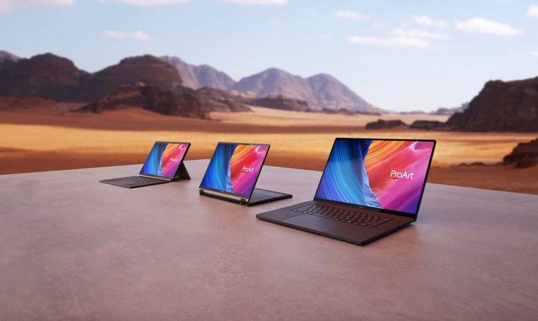 Three laptops outside in the desert for some reason. 