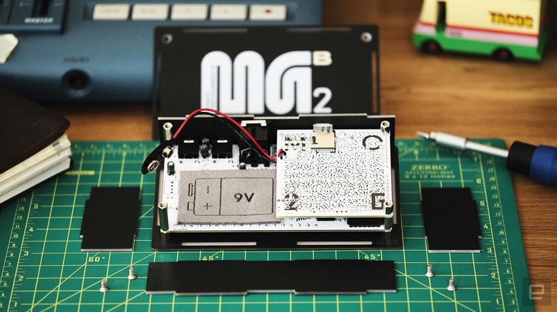 Bastl Instruments Microgranny Monolith splayed open to change the battery.