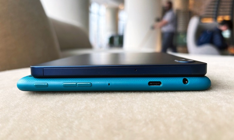 The Onn has a slightly thinner but more boxy shape, while the Fire HD 8 has more rounded edges.