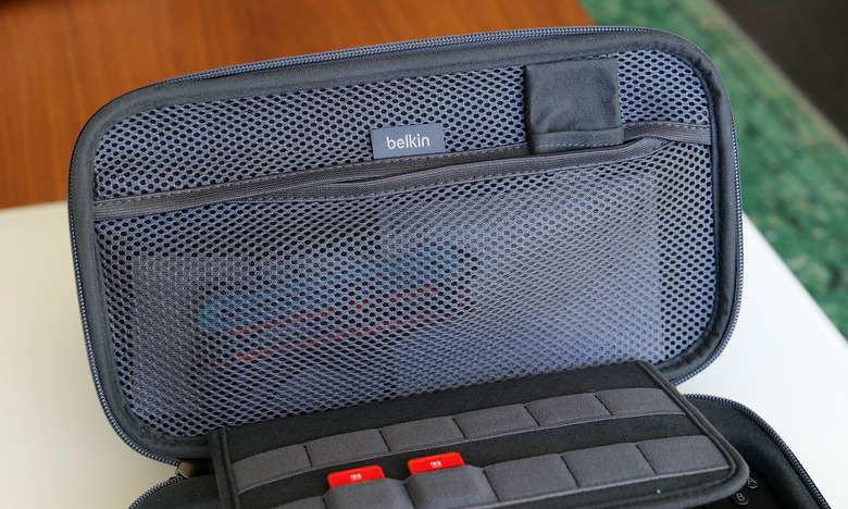 The inside of the Pro Charging Case features a handy mesh pocket, 12 slots for game carts and a hidden AirTag pouch.