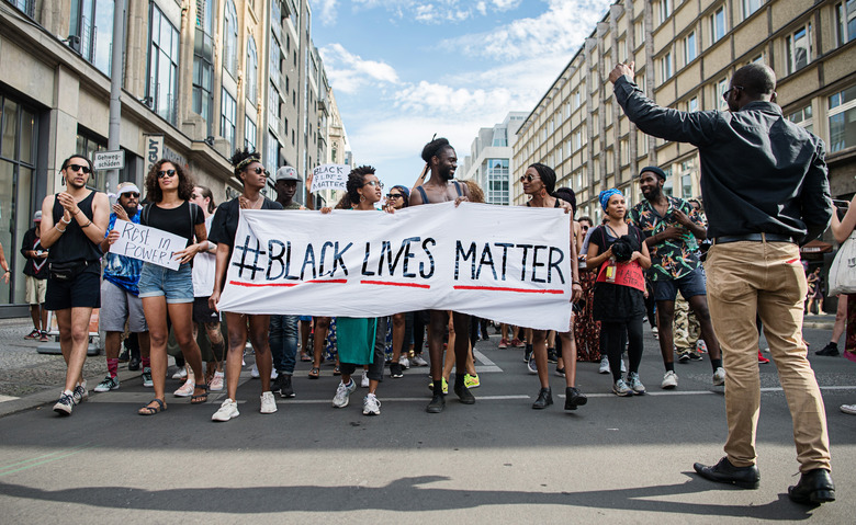 Demonstrators held a banner with the motto of the black civil rights movement with the twitter hashtag 