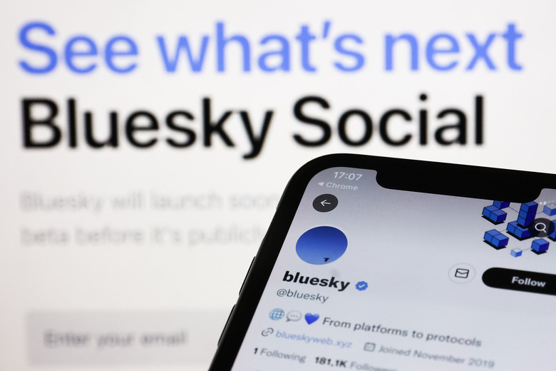 Bluesky Twitter account displayed on a phone screen and Bluesky Social website displayed on a screen in the background are seen in this illustration photo taken in Krakow, Poland on November 5, 2022. (Photo by Jakub Porzycki/NurPhoto via Getty Images)