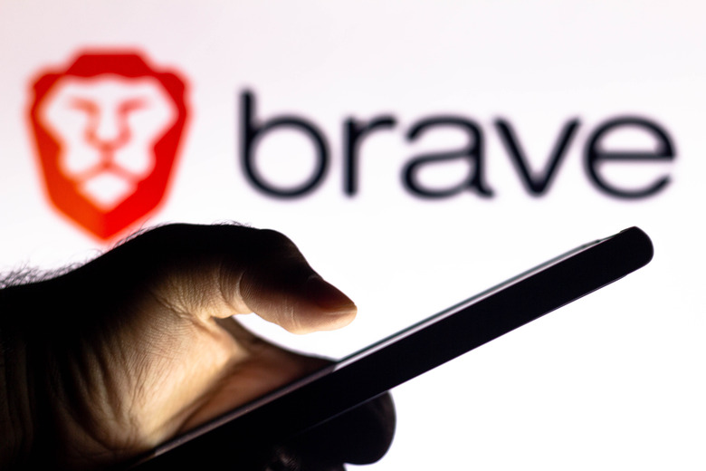 BRAZIL - 2021/01/20: In this photo illustration, a hand of a person holds a smartphone with a Brave Browser logo displayed in the background. (Photo Illustration by Rafael Henrique/SOPA Images/LightRocket via Getty Images)
