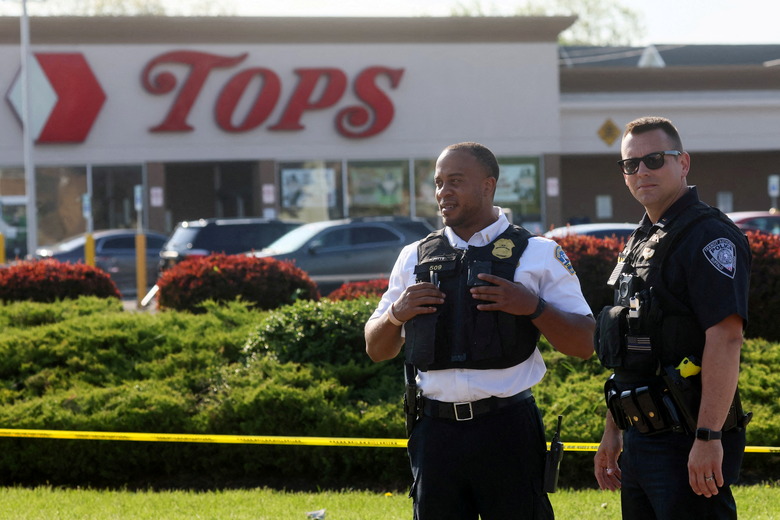 Law-enforcement officers stand guard outside TOPS supermarket following a shooting in Buffalo, New York, U.S. May 15, 2022. REUTERS/Brendan McDermid