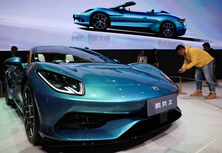 A man films the newly presented Z Convertible EV of BYD's luxury brand Denza at the company’s booth at the Beijing International Automotive Exhibition (Auto China), in Beijing, China, April 24, 2026. REUTERS/Maxim Shemetov