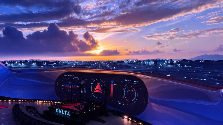 A backdrop of a plane landing on a runway with a sunset on the horizon. In the bottom middle of the picture is a small stage that says Delta.
