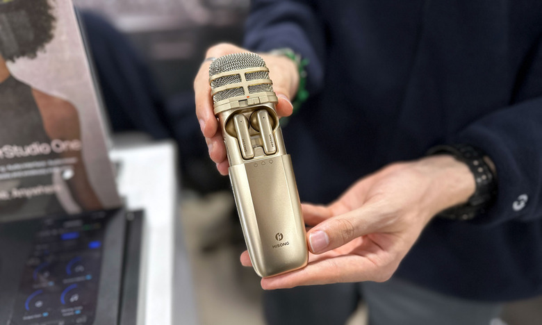 The AirStudio One microphone with the body open, revealing the pair of TWS earphones inside.