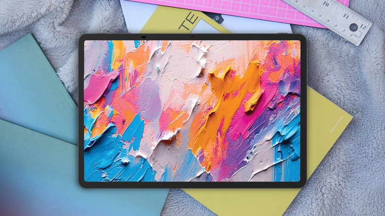 The TCL NXTPAPER 11 Plus tablet sits on an artistic background and displays realistic looking paint splotches.