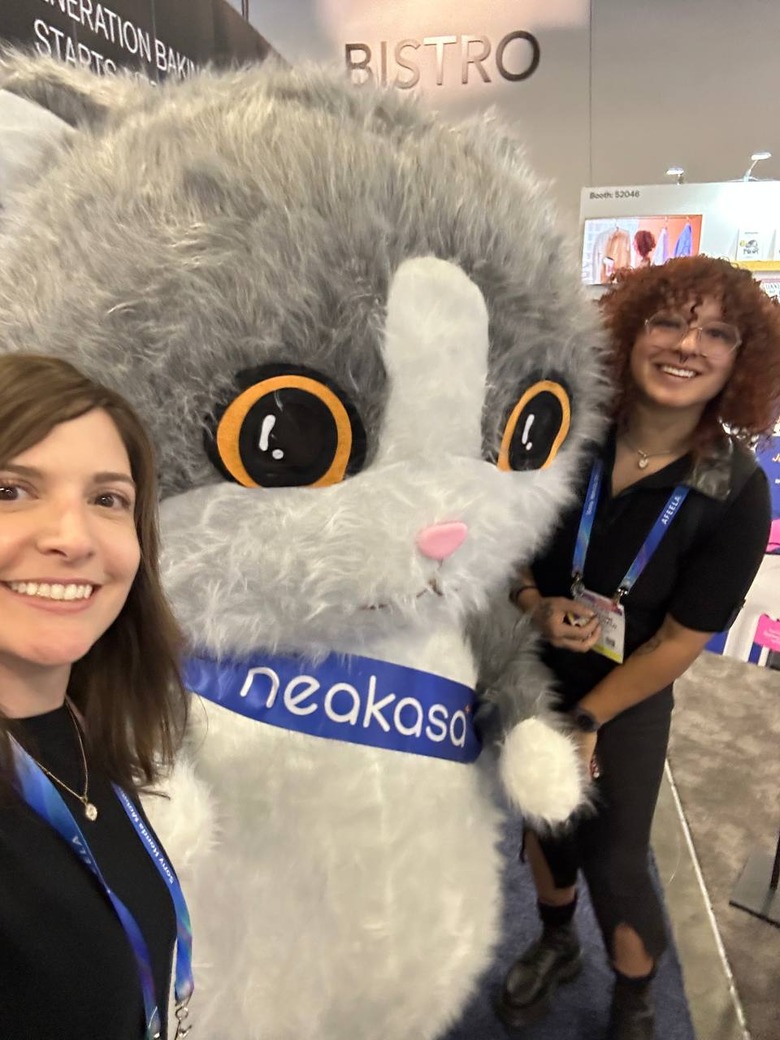 Karissa Bell and Cheyenne MacDonald from Engadget, posing with a large furry mascot at CES 2026.